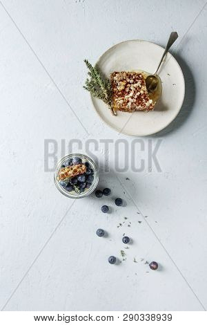 Homemade Classic Dessert Panna Cotta With Blueberry Berries In Jars, Decorated By Mint, Thym, Honey 