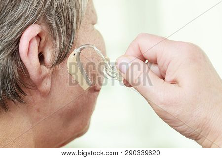 Closeup Senior Woman With Hearing Aid In Her Ear. Health Care, Hear Amplify, Device For The Deaf.