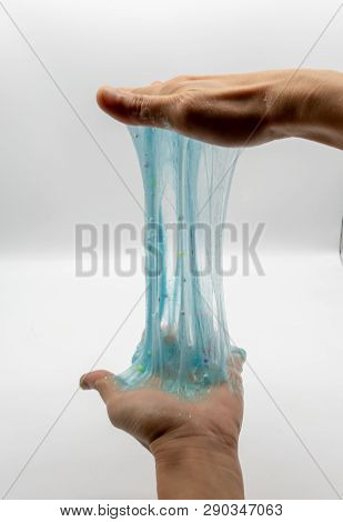 Hand Strecthing Transparent Blue Glitter Slime Isolated On White