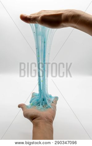 Hand Strecthing Transparent Blue Glitter Slime Isolated On White