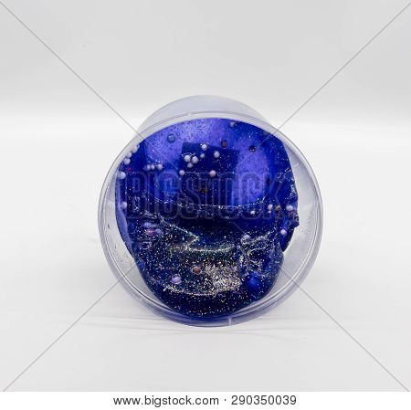 Dark Transparent Blue Glitter Slime In Clear Plastic Container Isolated On White