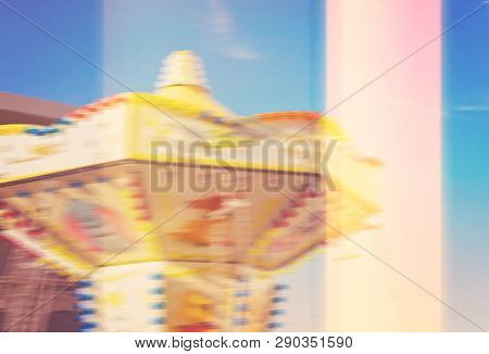 Abstract Slow Motion View Of Rotating Carousel Against Blue Sky With Glitch Light Leak Effect, Blurr