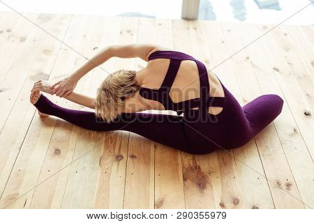Talented Well-trained Woman Leaning On Wall With Both Legs