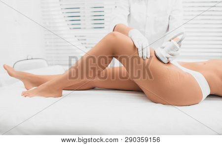Woman Having Cavitation Procedure On Legs And Buttocks , Cellulite Treatment At Beauty Clinic