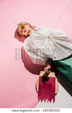 Beautiful Stylish Yoiung Woman In Sunglasses And Paper Clothes On Pink And White