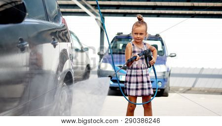 Little Girl Washing Auto In Self-serve Car Wash