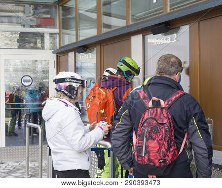 Kaprun, Austria, March 12, 2019: People Skiers Buyingtheir Ski Pass At Tickets Office At Kitzsteinho