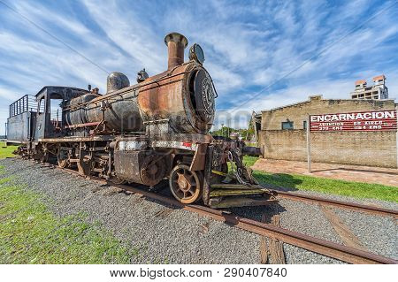 Encarnacion, Paraguay - November 14, 2018: Old Rusted Steam Locomotive In Encarnacion. In Paraguay T