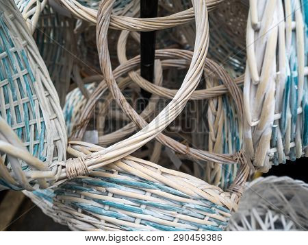 Empty Wicker Baskets With The Handle. Hang On A Column In Shop. White Baskets