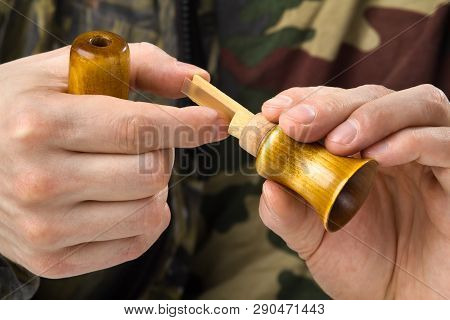 Hands Of The Hunter Dismantled A Wooden Single Reed Call For Cleaning, Closeup