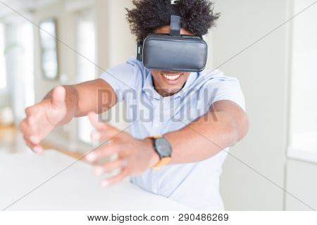 African amaerican man having fun playing with virtual reality glasses