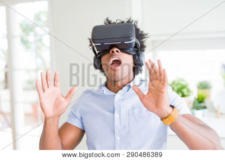 African amaerican man having fun playing with virtual reality glasses