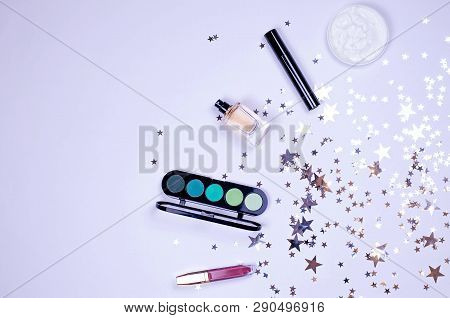 Flatley Of Female Cosmetics And Glittering Stars On A Gray Background. There Is A Place For Text.