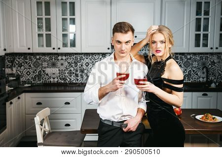 Portrait View Of Embrasing Couple In Ceremonial Clothes At The Kitchen
