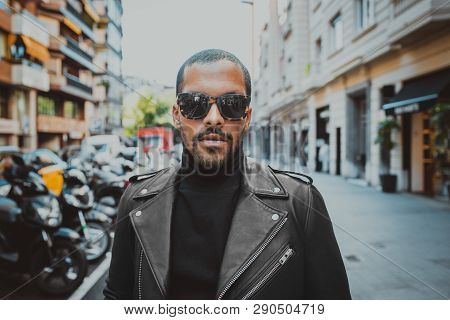 Confident African American Man Wearing On Sunglasses And Black Leather Jacket Outdoor. Street Wear F