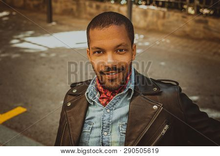 Confident Smiling African American Man Wearing Black Leather Jacket Outdoor. Street Wear Fashion Bla