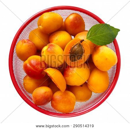 Fresh Bright Orange Appricotes In Red Plate On White. Top View, Close Up.