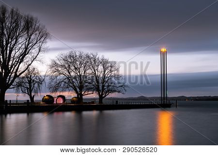The Lighthouse Of The Harbor In Bregenz (austria) After Sunset, Lake Constance (bodensee) In Early S