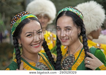 September, 3, 2017. Ashgabat, Turkmenistan : Two Smiling Young Girls In Green National Dresses Befor