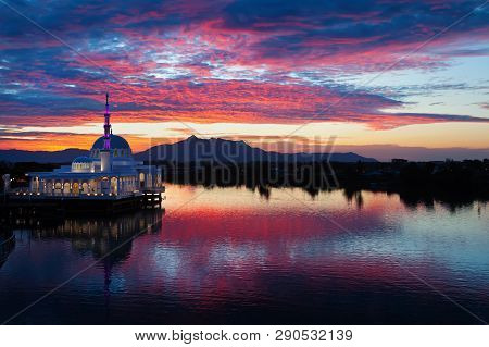 Scenic View Of Floating Mosque On Sarawak River With Colorful Sunset Clouds Background. Waterfront L