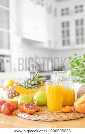 Multifruit Juice And Fresh Fruit On Table On Kitchen Background Closeup