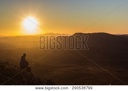 Man Enjoying Sunset After A Hike To The Top Of Mount Sonder Just Outside Alice Springs, West Macdonn