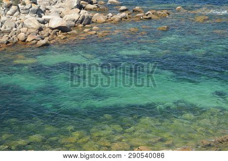 Turquoise Waters Surrounding The Fort Of The Hermitage At La Lanzada In Noalla. Nature, Architecture