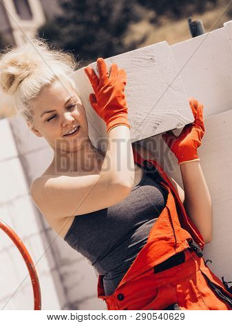 Strong Pretty Woman Working On Construction Site, Building House, Installing Gray Airbricks. Industr