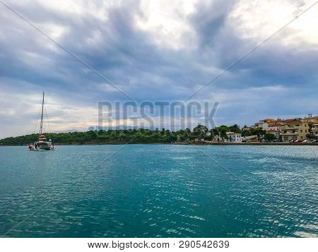 View From The Yacht To The Island With The Traditional Architecture In The Greek Style