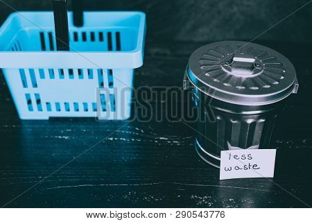 Spend Better For Less Waste Shopping Basket Next To Gargabe Bin