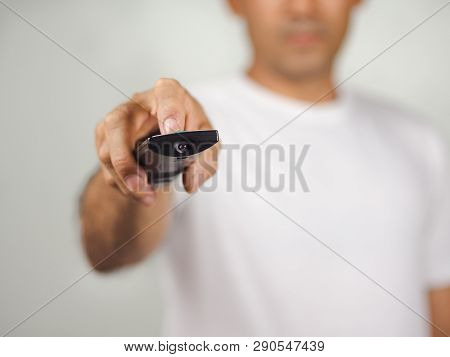 Closeup Of A Man Pess The Remote Controller Button On White Background