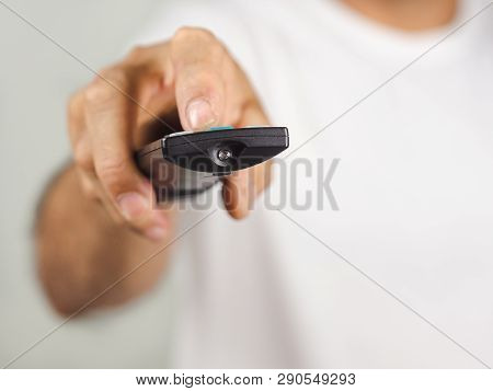 Closeup Of A Man Pess The Remote Controller Button On White Background