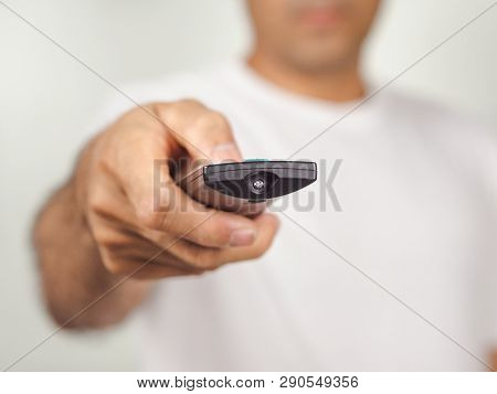 Closeup Of A Man Pess The Remote Controller Button On White Background