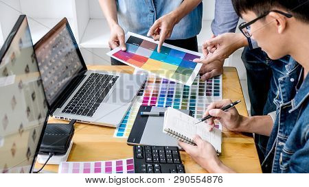 Team Of Young Colleagues Creative Graphic Designer Working On Color Selection And Drawing On Graphic