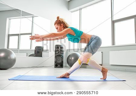 Attractive Sportswoman Doing Exercises On The Floor In The Modern Palates Studio Beautiful Sportive 