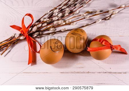 Pussywillow Bouquet And Easter Eggs On White Wooden Table.