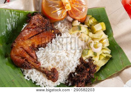 Nasi lemak kukus with chicken, popular traditional Malay local food.
