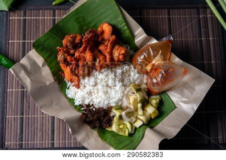 Nasi kukus ayam berempah, popular traditional Malay local food. Flat lay top down overhead view.