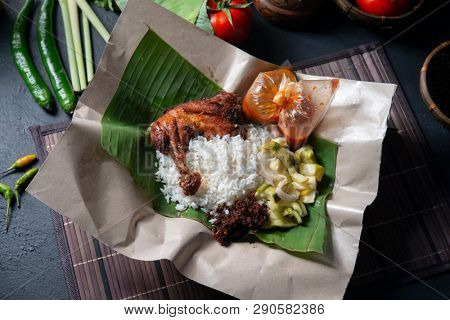 Nasi lemak kukus with chicken, popular traditional Malay local food. Flat lay top down overhead view.