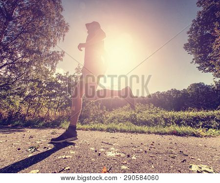 Running Sportsman Freeze Within Quick Moment In Front Of Camera. Regular Training Long Trees In Natu