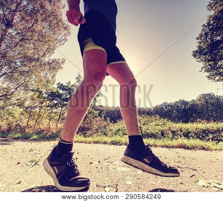 Running Sportsman Freeze Within Quick Moment In Front Of Camera. Regular Training Long Trees In Natu