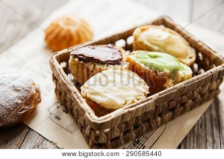 Homemade Profiteroles On The Music Sheet With Notes. Profiteroles (choux à La Crème) - French Choux