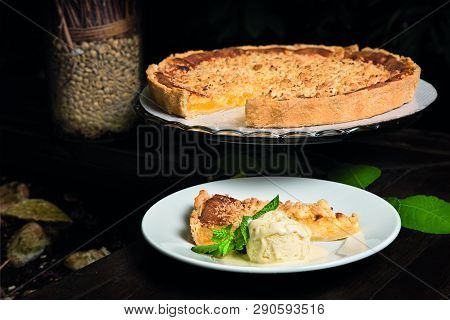 Lemon Tart With Mint And Ice Cream On A Table