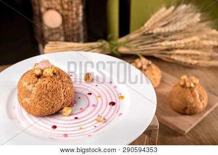 Homemade Violet Profiterole Served In White Plate.
