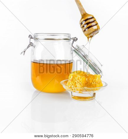 Honey In A Glass Jar Isolated In White Background