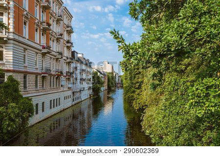 Apartment Buildings On Bank Of River Or Canal In Residential District Of Hamburg Eppendorf, Germany 