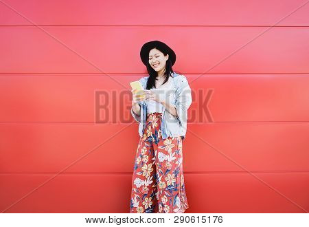 Happy Asian Girl Using Mobile Phone Outdoor - Chinese Social Influencer Having Fun With New Trends S
