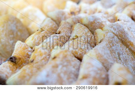 Close Up Shot Of Chocolate Jelly Doughnut Cruller With White Sugar Topping. Selective Focus.
