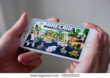 Los Angeles, California, Usa - 8 March 2019: Hands Holding A Smartphone With Minecraft Pocket Editio