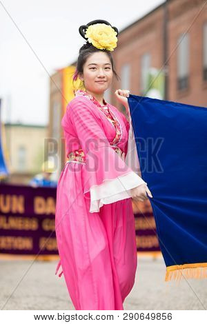 Holland, Michigan, Usa - May 12, 2018 Chinese Women Wearing Traditional Clothing Holding A Sign Prom